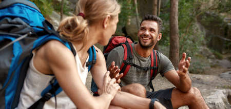 Happy young caucasian couple of tourists resting