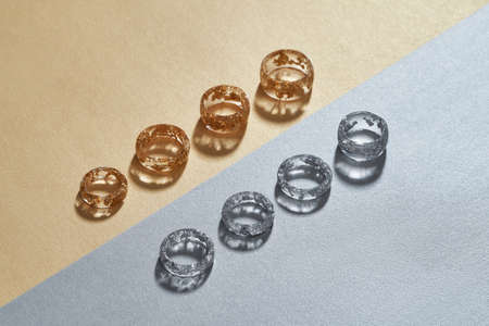 Transparent resin rings with golden and silver filling