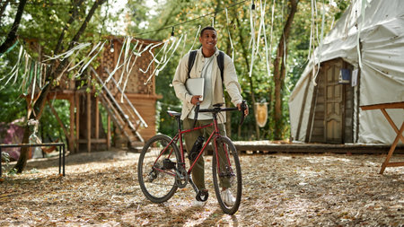 Cheerful young african american man with laptopの写真素材