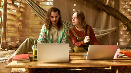 front view on a couple working and discussing design on fresh air