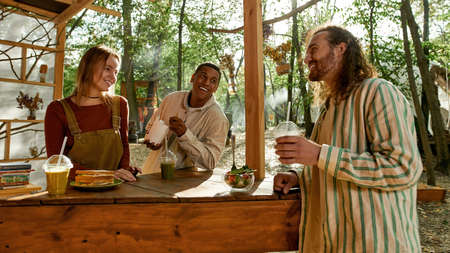 Team of happy young multiracial workers having lunchの写真素材