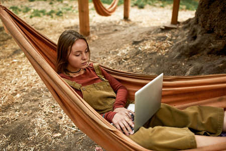 Top view of a young girl surfing the net on the fresh airの写真素材