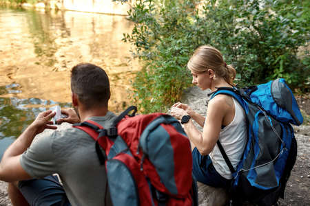 Young caucasian couple of tourists eating snacks