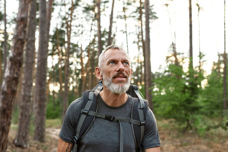 Portrait of mature caucasian man with tourist backpackの写真素材