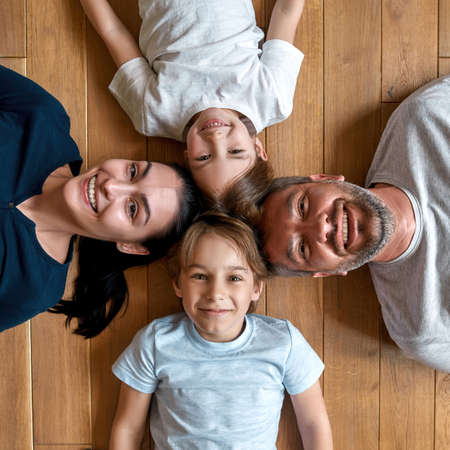 Portrait of smiling parents with small kids relaxの写真素材