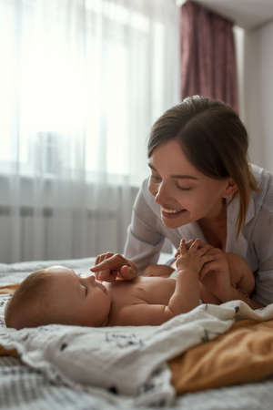 Tender touches to wake up lovely babyの写真素材