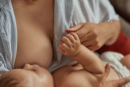 Skin-to-skin contact between mother and baby, close viewの写真素材
