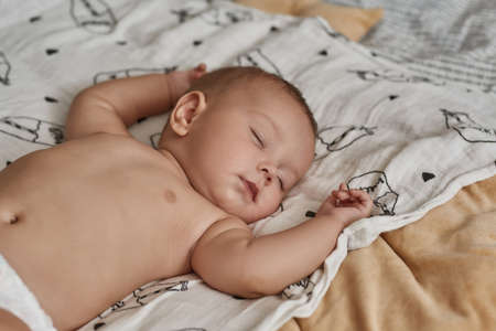 Handsome infant baby boy peacefully sleeping without clothesの写真素材