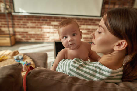 Cute baby boy held by his mother