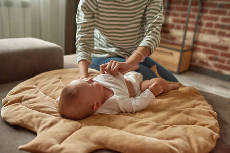 Lovely baby boy being dressed after shower