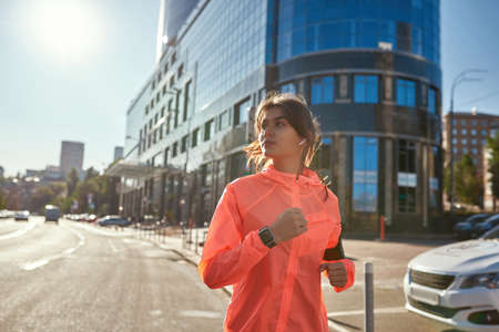 Active woman in headphones sportswear run outdoorsの写真素材