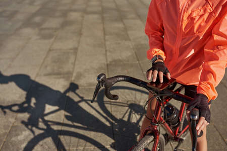 Close up of woman use smartphone cycling outdoorsの写真素材