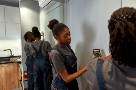Young attractive woman learning to be electricianの写真素材