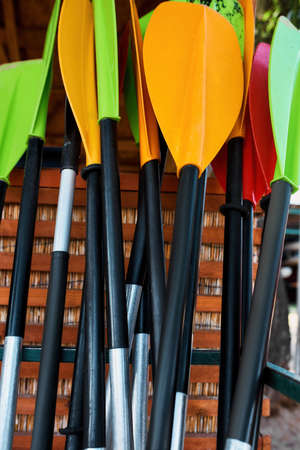 Collection of different kayak paddles in garage