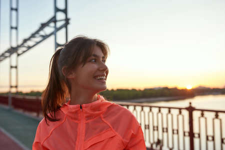 Happy sporty girl in sportswear training running outdoorsの写真素材
