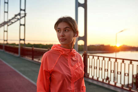 Millennial fit girl workout outdoors in headphones