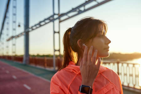 Millennial active woman in earphones run jog outdoorsの写真素材