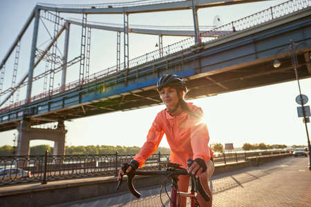Active millennial female cyclist ride bike trainingの写真素材