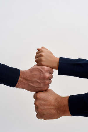 Crop shot of three generations of men stack fistsの写真素材