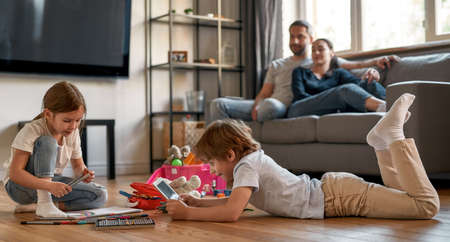 Little kids relax at home playing toysの写真素材