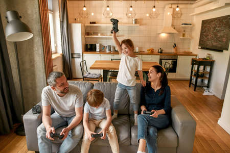Excited little girl celebrate win playing video game