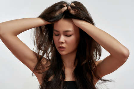 Young Asian woman isolated on white studio background