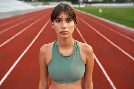 Young european sports woman on stadium treadmillの写真素材