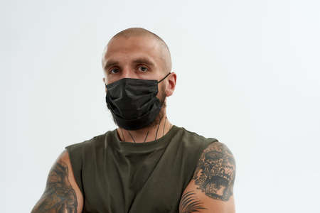 Caucasian man in medical mask looking at cameraの写真素材