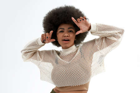 Young black woman posing and looking at camera