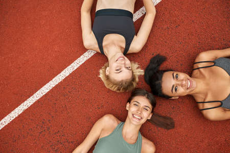 Top view of smiling sports women on treadmillの写真素材