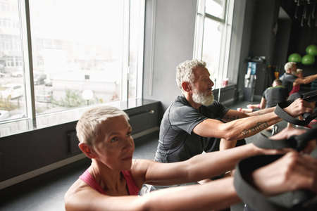 Stereotype-free mature sporty people in gymの写真素材