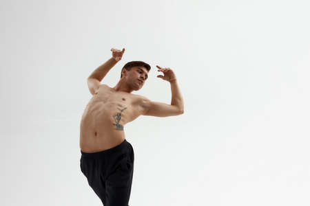 Male dancer listen music in earphones and dancingの写真素材