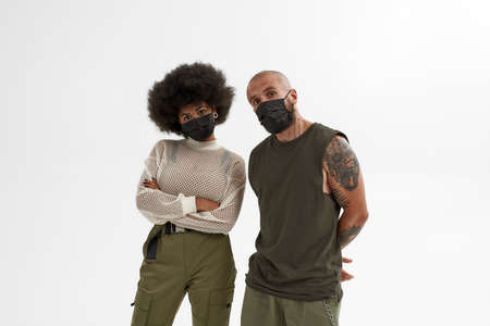 Caucasian man and black woman in medical masks