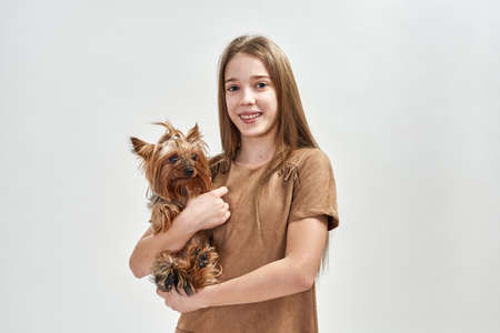 Girl holding her purebred Yorkshire Terrier dogの写真素材