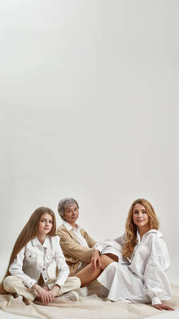 Vertical portrait of three generations of Caucasian womenの写真素材