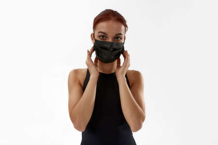 Ballet dancer correcting medical mask on faceの写真素材