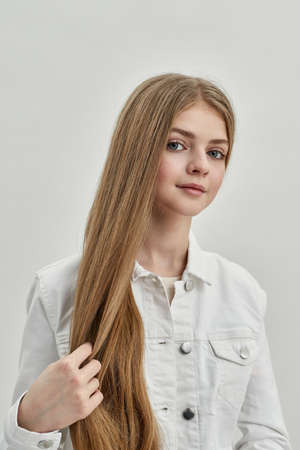 Portrait of beautiful teenage girl child on white backgroundの写真素材