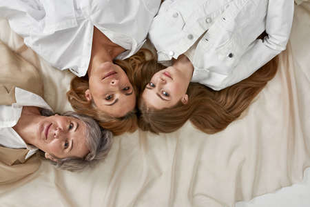 Top view portrait of three generations of women rest togetherの写真素材