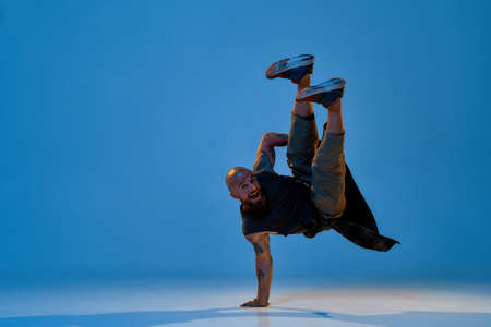 Young caucasian male dancer dancing break danceの写真素材
