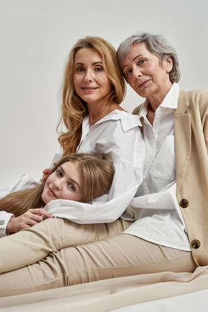 Narrow portrait of smiling three generations of womenの写真素材