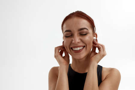 Joyful caucasian woman listen music in earphonesの写真素材
