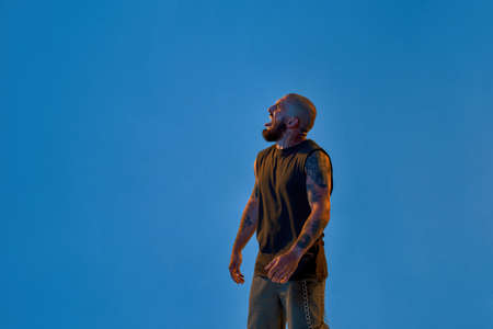 Irritated man sticking out tongue and looking awayの写真素材