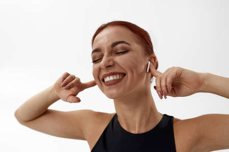 Smiling caucasian woman listen music in earphonesの写真素材