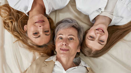 Wide portrait of three generations of Caucasian womenの写真素材