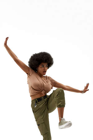 Beautiful curly brunette woman dancing hip hopの写真素材