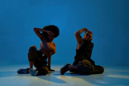 Multiracial man and woman dancing hip hop dance