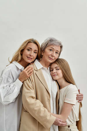 Caucasian family hug each other and look at camera
