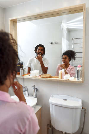 Young black couple brushing teeth at morningの写真素材