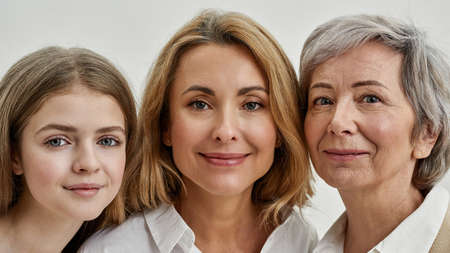 Close up of smiling three females look at cameraの写真素材