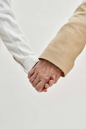 Cropped of grandmother and girl holding hands